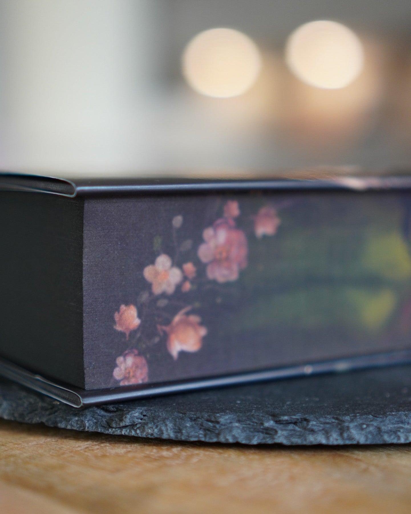 Book with floral design on a wooden surface